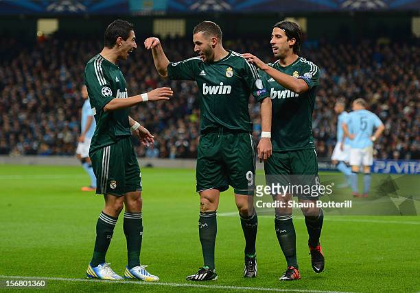 Karim Benzema of Real Madrid celebrates scoring the opening goal with team-mates Angel Di Maria and Sami Khedira during the UEFA Champions League...