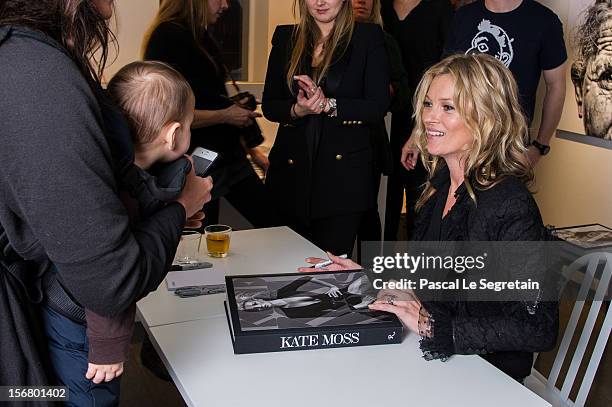 Kate Moss signs her book 'Kate: The Kate Moss Book' at Colette on November 21, 2012 in Paris, France.