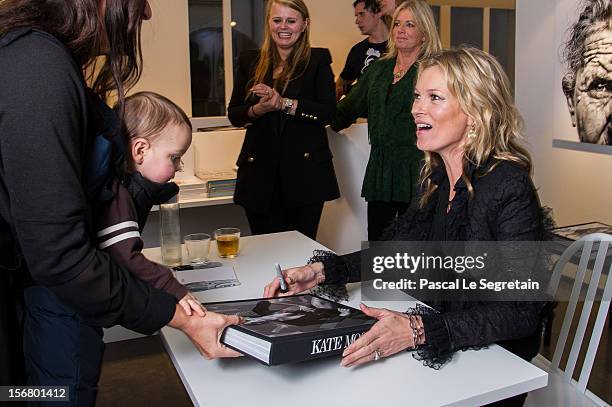 Kate Moss signs her book 'Kate: The Kate Moss Book' at Colette on November 21, 2012 in Paris, France.