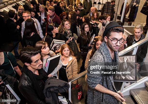 Fans queue to attend the Kate Moss signing session for the book 'Kate: The Kate Moss Book' at Colette on November 21, 2012 in Paris, France.