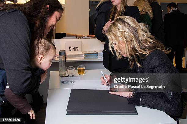 Kate Moss signs her book 'Kate: The Kate Moss Book' at Colette on November 21, 2012 in Paris, France.