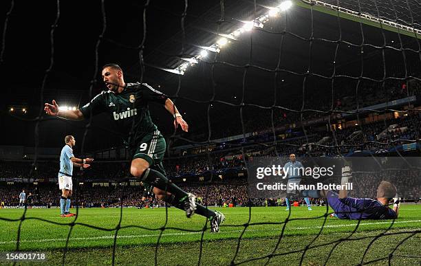 Karim Benzema of Real Madrid celebrates scoring the opening goal past Joe Hart of Manchester City during the UEFA Champions League Group D match...