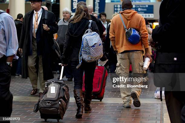 Travelers pull luggage while heading to trains at Union Station in Washington, D.C., U.S., on Wednesday, Nov. 21, 2012. U.S. Travel during the...