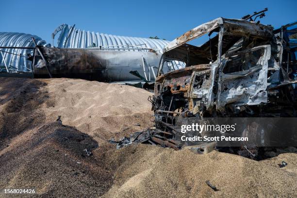 Ukrainians salvage barley and peas three days after five Russian missiles struck a grain storage facility in the village of Pavlivka, Odesa region,...