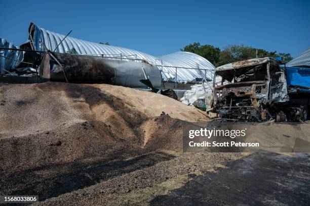 Ukrainians salvage barley and peas three days after five Russian missiles struck a grain storage facility in the village of Pavlivka, Odesa region,...