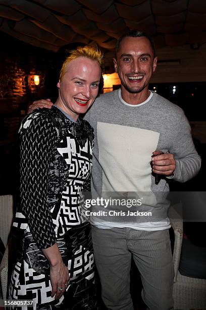Louise Grey and Richard Nicoll celebrate winning £100 for the Kids Company charity during the Vodafone Fashionable Pub Quiz at Shoreditch House on...