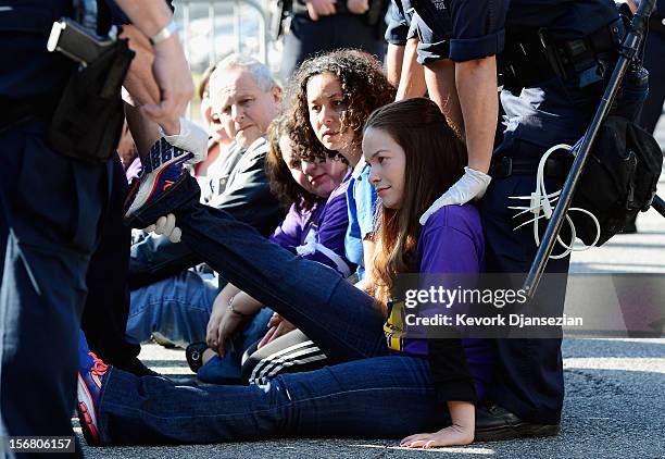 Several protesters are arrested by Los Angeles Police Department officers during a large march by service employees and members from several other...