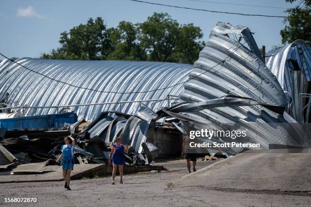 Ukrainian workers vacate a grain storage facility during an air raid alert, three days after five Russian missiles struck the facility in the village...