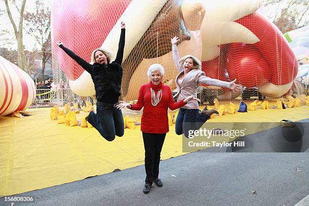 Twin sisters Chanda Bell and Christa Pitts celebrate with their mother, "The Elf on the Shelf" co-author Carol Aebersold, at the inflation of the new...