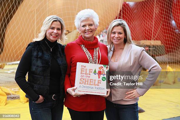 Twin sisters Chanda Bell and Christa Pitts celebrate with their mother, "The Elf on the Shelf" co-author Carol Aebersold, at the inflation of the new...