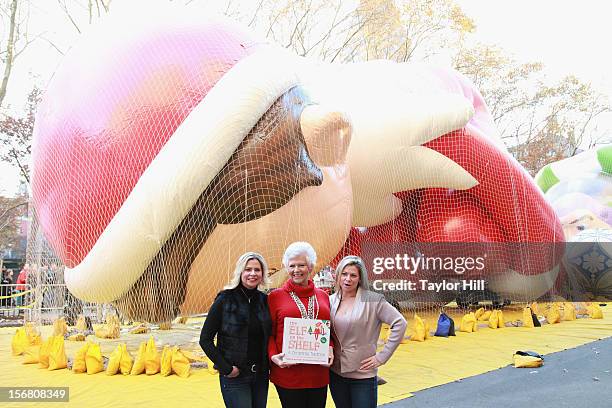 Twin sisters Chanda Bell and Christa Pitts celebrate with their mother, "The Elf on the Shelf" co-author Carol Aebersold, at the inflation of the new...