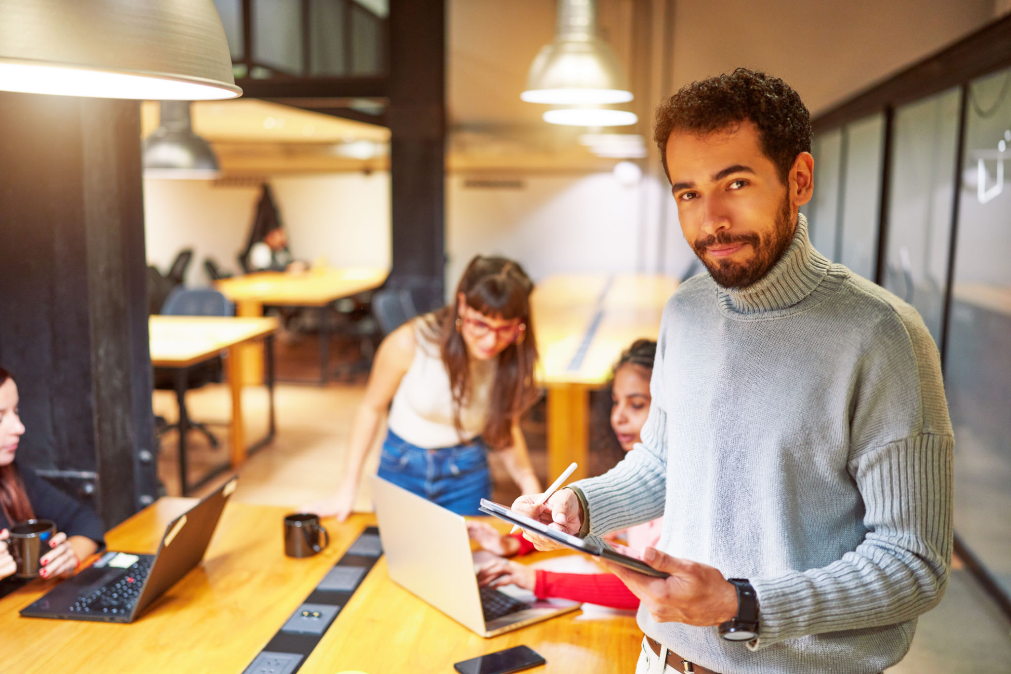 portrait cheerful young Latin American businessman or employee looking at camera in meeting room portrait cheerful young Latin American businessman or employee looking at camera in meeting room