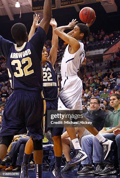 Cameron Biedscheid of the Notre Dame Fighting Irish looks to pass off the ball as Isaiah Armwood of the George Washington Colonials and Joe McDonald...