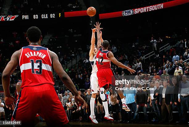 Kyle Korver of the Atlanta Hawks hits a go-ahead three-point basket over A.J. Price of the Washington Wizards in the final seconds at Philips Arena...