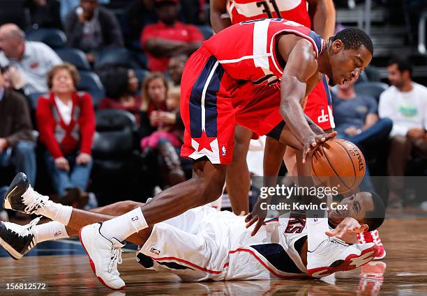 Devin Harris of the Atlanta Hawks reaches for a steal against Jordan Crawford of the Washington Wizards at Philips Arena on November 21, 2012 in...