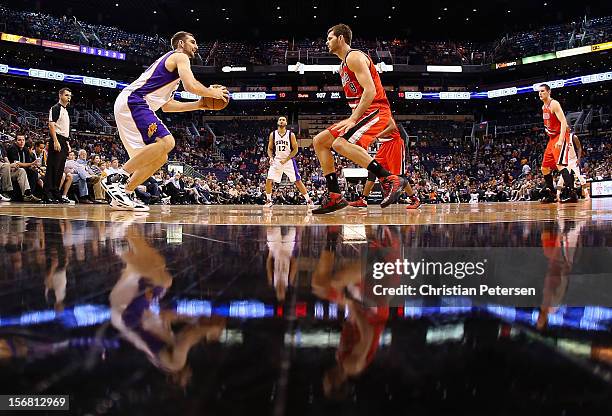 Luke Zeller of the Phoenix Suns looks to shoot guarded by Elliot Williams of the Portland Trail Blazers during the NBA game at US Airways Center on...