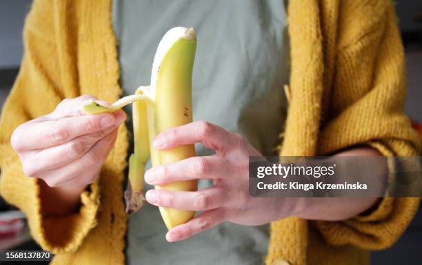 peeling banana - banana stock pictures, royalty-free photos & images