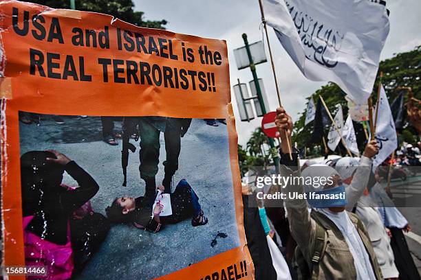 Muslim activists from Hizbut Tahrir Indonesia protest during against the Israel and US governments as against Israeli air strikes on the Gaza Strip...