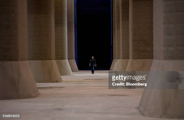 Visitor walks through the surge tank area of the Metropolitan Area Outer Underground Discharge Channel in Kasukabe City, Saitama Prefecture, Japan,...