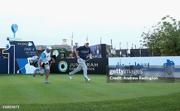 Richard Finch of England and his caddie Kyle Roadley run off of the first tee after the opening tee shot during the first round of the DP World Tour...