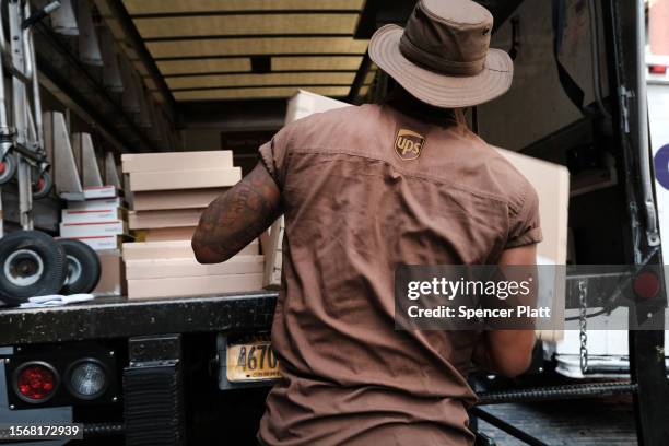 Carlos, a UPS worker in Manhattan, delivers packages on his daily rounds on July 24, 2023 in New York City. UPS workers will go back to the...