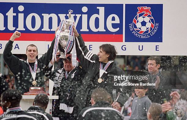 Fulham players Andy Melville and Chris Coleman celebrate winning the title with chairman Mohamed Al-Fayed after the Nationwide League Division One...