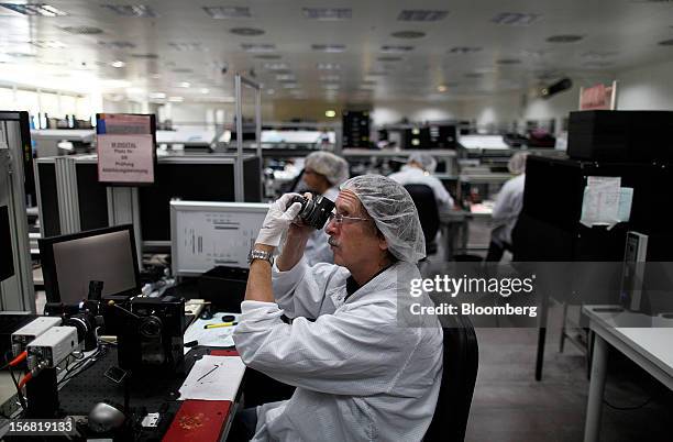 Technician checks the viewfinder function of a Leica M series digital camera at the Leica Camera AG headquarters in Solms, Germany, on Wednesday,...