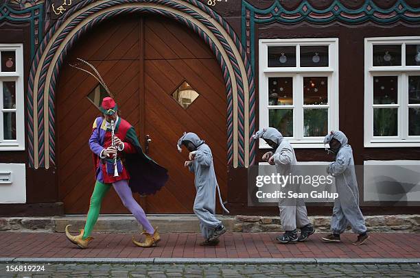 The Pied Piper of Hamelin, actually city tourism employee Michael Boyer, leads local children dressed as rats through a quiet street on November 19,...