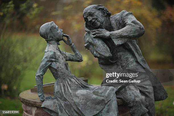 Bronze sculpture depicts a grandfather recounting a fairy tale to his dranddaughter on November 19, 2012 in Schoeneberg, Germany. Schoeneberg lies...