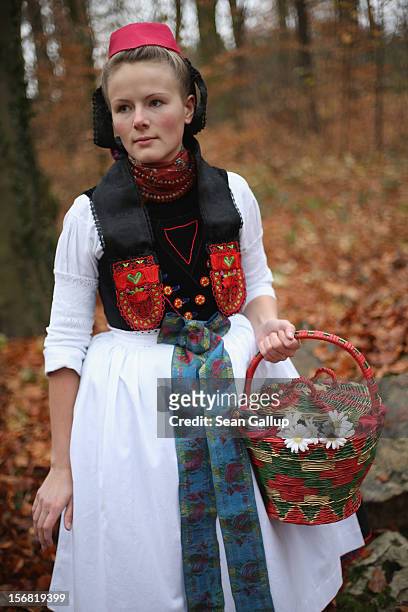 Little Red Riding Hood , actually actress Dorothee Weppler, wears the local Schwalm region folk dress with its red cap as she walks through a forest...