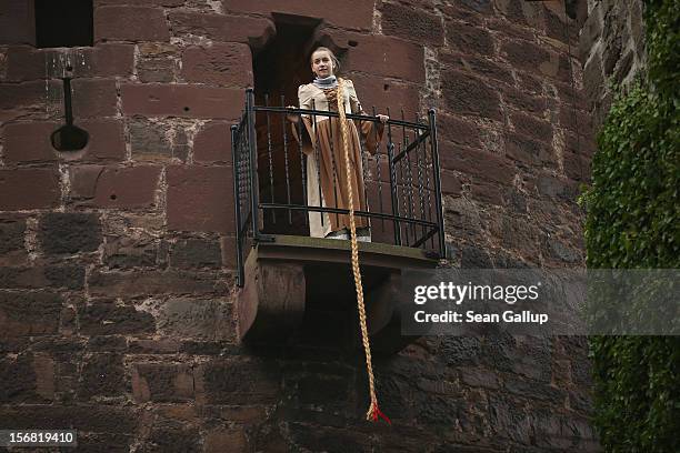 Rapunzel, actually 13-year-old actress Anna Helver, lets down her hair from a tower balcony of Trendelburg Castle to her prince on November 18, 2012...