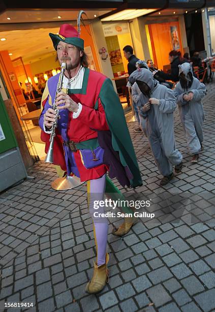 The Pied Piper of Hamelin, actually city tourism employee Michael Boyer, leads local children dressed as rats through a pedestrian shopping street on...