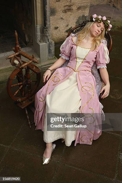 Sleeping Beauty, played by actress Elisabeth Knoche, reclines in her 100-year sleep after she pricked her finger on a spindle at Sababurg Palace on...