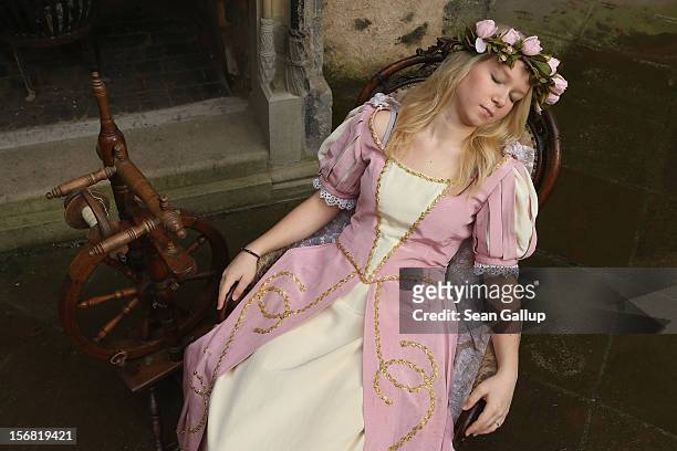 Sleeping Beauty, played by actress Elisabeth Knoche, reclines in her 100-year sleep after she pricked her finger on a spindle at Sababurg Palace on...