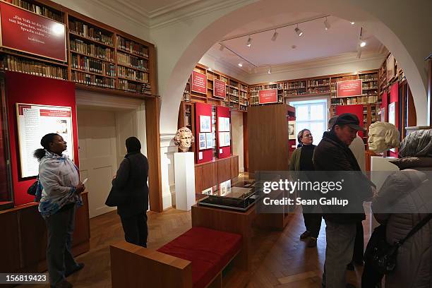 Visitors walk among busts of brothers Jacob and Wilhelm Grimm in the library at the Grimm Brothers Museum on November 20, 2012 in Kassel, Germany.The...