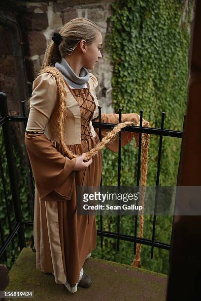 Rapunzel, actually 13-year-old actress Anna Helver, lets down her hair from a tower balcony of Trendelburg Castle to her prince on November 18, 2012...
