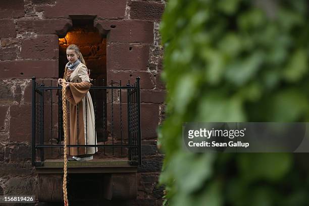 Rapunzel, actually 13-year-old actress Anna Helver, lets down her hair from a tower balcony of Trendelburg Castle to her prince on November 18, 2012...