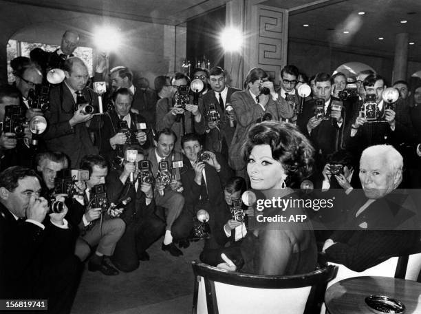 British actor, author and film director Charlie Chaplin and Italian film star Sophia Loren give a press conference to announce their film "A Countess...