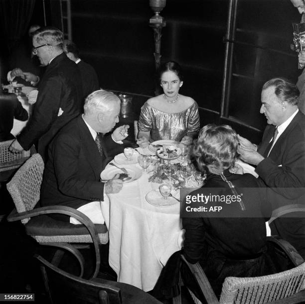 British actor, author and film director Charlie Chaplin has dinner at La Tour d'Argent restaurant in Paris on October 30, 1952 with his wife Oona...