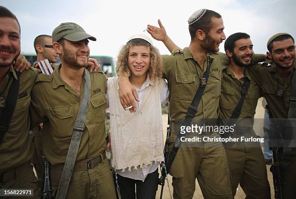 Hassidic Jewish boys show their support and dance with Israeli soldiers at the border with the Gaza Strip on November 22, 2012 close to the northern...
