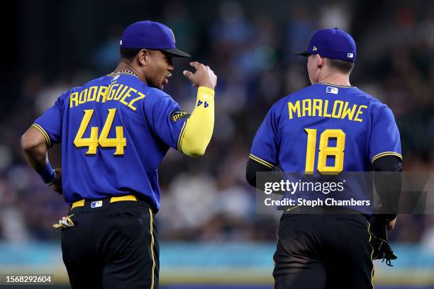 Julio Rodriguez and Cade Marlowe of the Seattle Mariners run to the outfield during the game against the Toronto Blue Jays at T-Mobile Park on July...