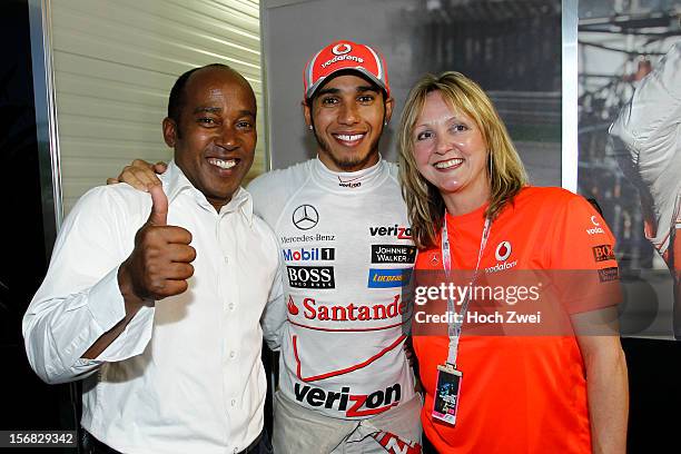 Lewis Hamilton of Great Briatin and McLaren celebrates his win with his father Anthony Hamilton and his step-mother Linda Hamilton during the United...