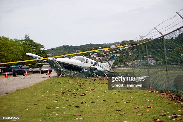 small plane crashes through fence on highway in emergency landing - aeroplane crash stock pictures, royalty-free photos & images