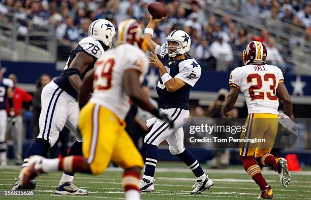 Tony Romo of the Dallas Cowboys looks for an open receiver under pressure from the Washington Redskins on Thanksgiving Day at Cowboys Stadium on...