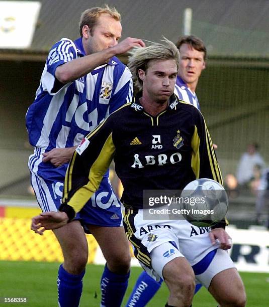 Goteborg defender Hakan Mild, left, attacks AIK forward Andreas Andersson during the Swedish National Soccer League Allsvenskan match in Gothenburg ....