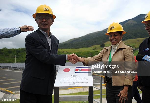 Costa Rican President Laura Chinchilla and Japanese ambassador Yoshiharu Namiki shake hands during the inauguration of the Miravalles Solar Power...