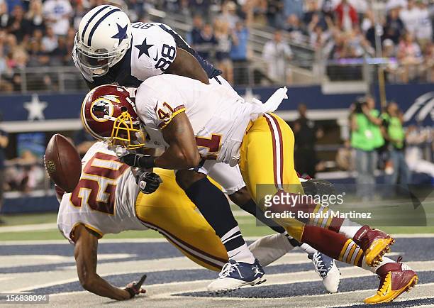 Dez Bryant of the Dallas Cowboys drops a pass in the endzone against Cedric Griffin and Madieu Williams of the Washington Redskins during a...