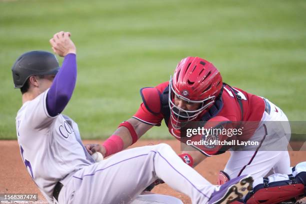 Keibert Ruiz of the Washington Nationals tags out Randal Grichuk of the Colorado Rockies running home on a Nolan Jones hit in the fourth inning...