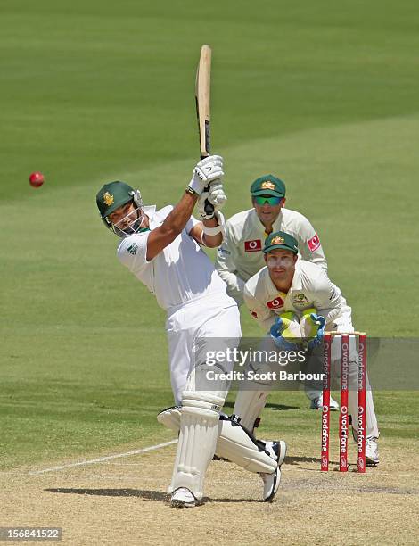 Alviro Petersen of South Africa hits a boundary as Michael Clarke and Matthew Wade of Australia look on during day two of the Second Test match...