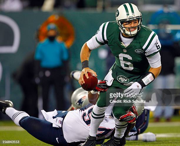 Quarterback Mark Sanchez of the New York Jets is sacked by Justin Francis of the New England Patriots during the first half of a game at MetLife...
